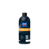 Bottiglia di CARTEC Textile Cleaner per la pulizia dei tessuti dell'auto, con etichetta arancione e tappo nero.