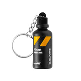 Portachiavi CARPRO Finest Reserve a forma di flacone nero con dettagli gialli e anello metallico, su sfondo bianco.